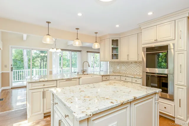 a kitchen with kitchen island a sink appliances and cabinets