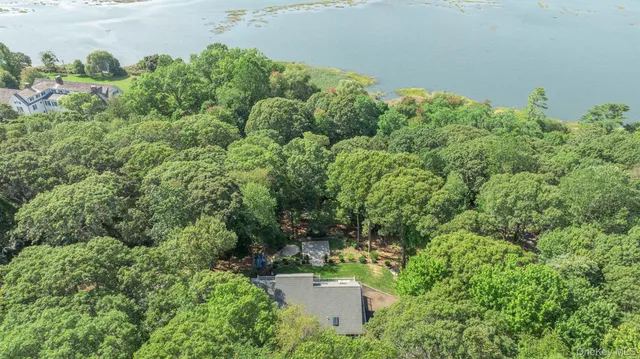 an aerial view of a house with a yard