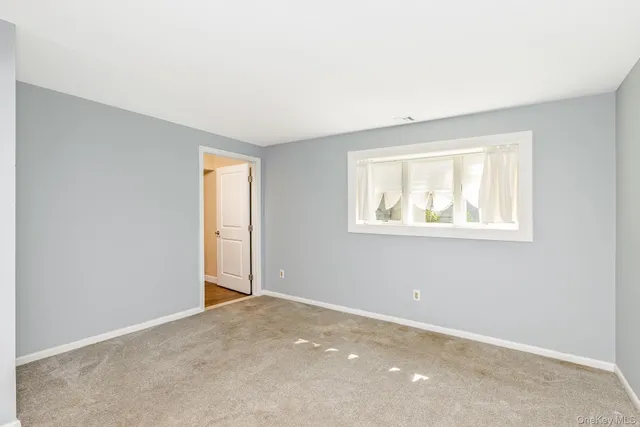 a bathroom with a granite countertop sink a mirror a shower and vanity