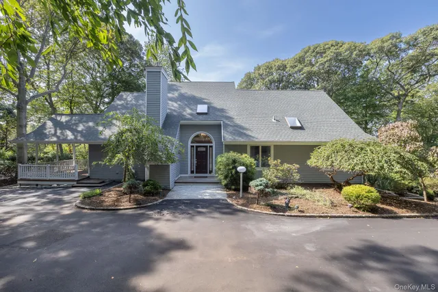 a view of a big house with a yard and plants