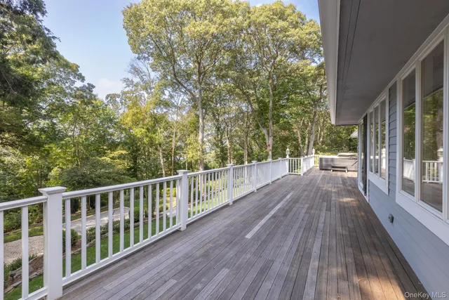 a view of balcony with wooden floor and fence
