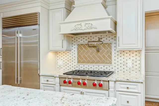 a kitchen with granite countertop a stove and a wooden cabinets