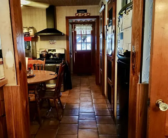 a dining room with furniture and a floor to ceiling window