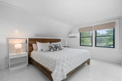 a bedroom with a bed and window