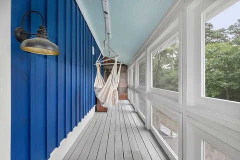 a view of balcony with wooden floor