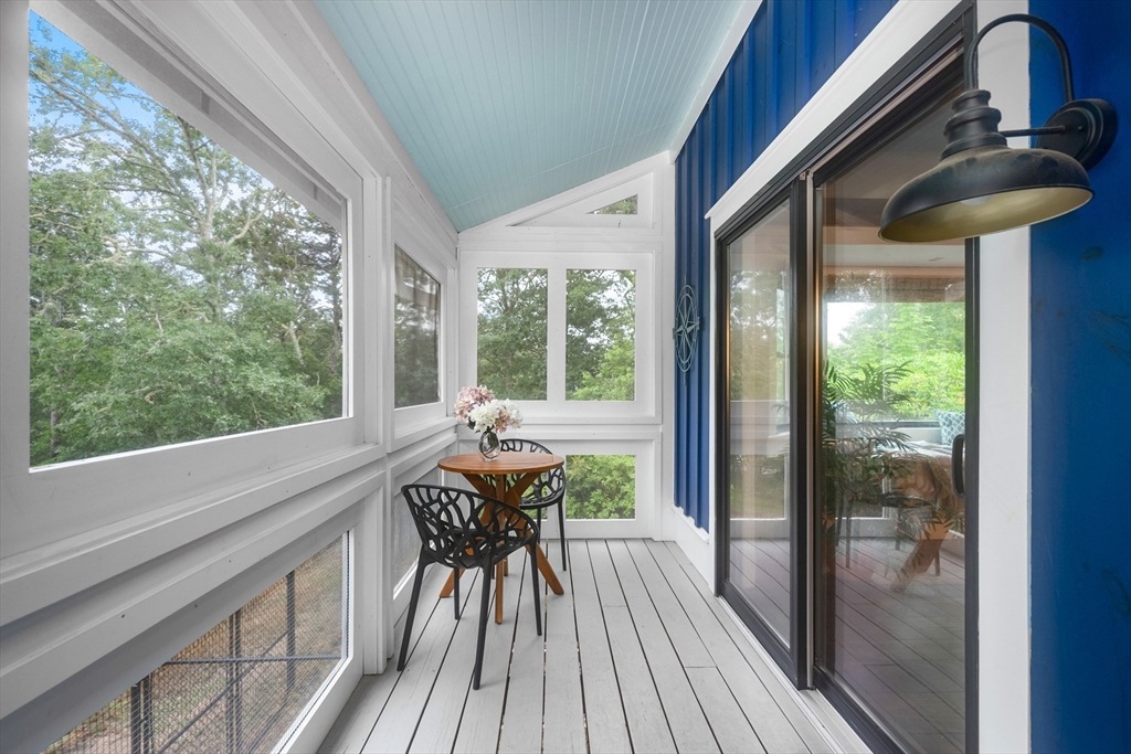 24 Chickadee Circle Chatham, MA 02633 - Photo 25 of 41 a view of a porch with furniture and wooden floor