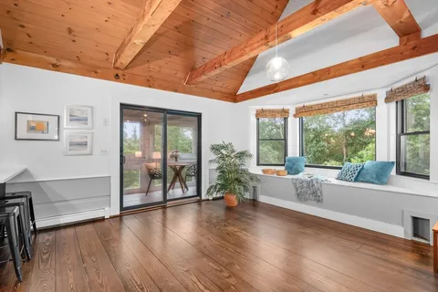 a living room with furniture and large windows