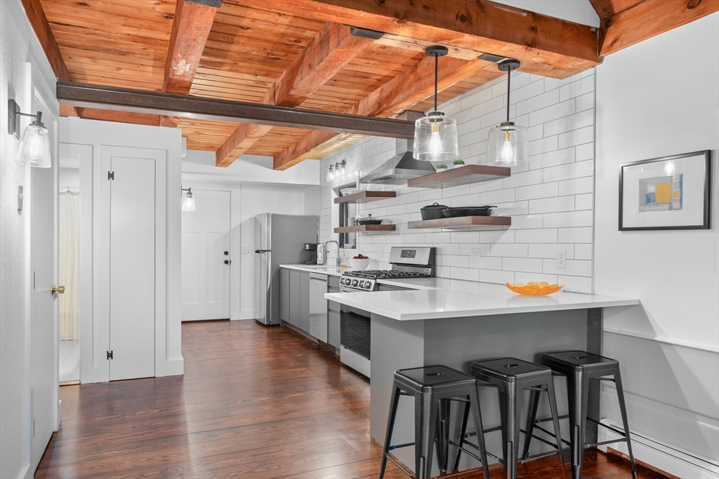 24 Chickadee Circle Chatham, MA 02633 - Photo 9 of 41 a kitchen with stainless steel appliances a white wooden cabinets and stove top oven