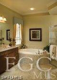 3142 Walnut Grove Lane Alva, FL 33920 - Photo 3 of 3 a bathroom with a tub sink and mirror
