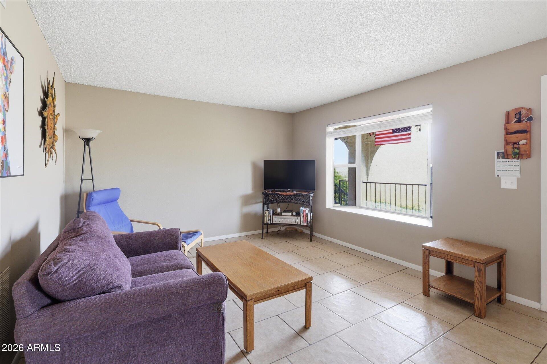 3270 South Goldfield Road, Unit 716 Apache Junction, AZ 85119 - Photo 11 of 36 a living room with furniture and a flat screen tv
