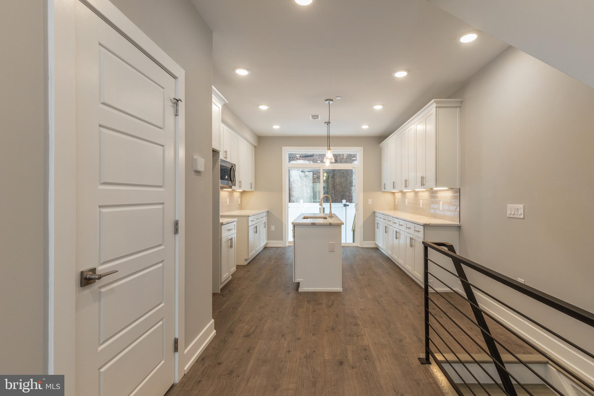 135 West Huntingdon Street, Unit 1 Philadelphia, PA 19133 - Photo 5 of 29 a view of a kitchen with white cabinets and stainless steel appliances