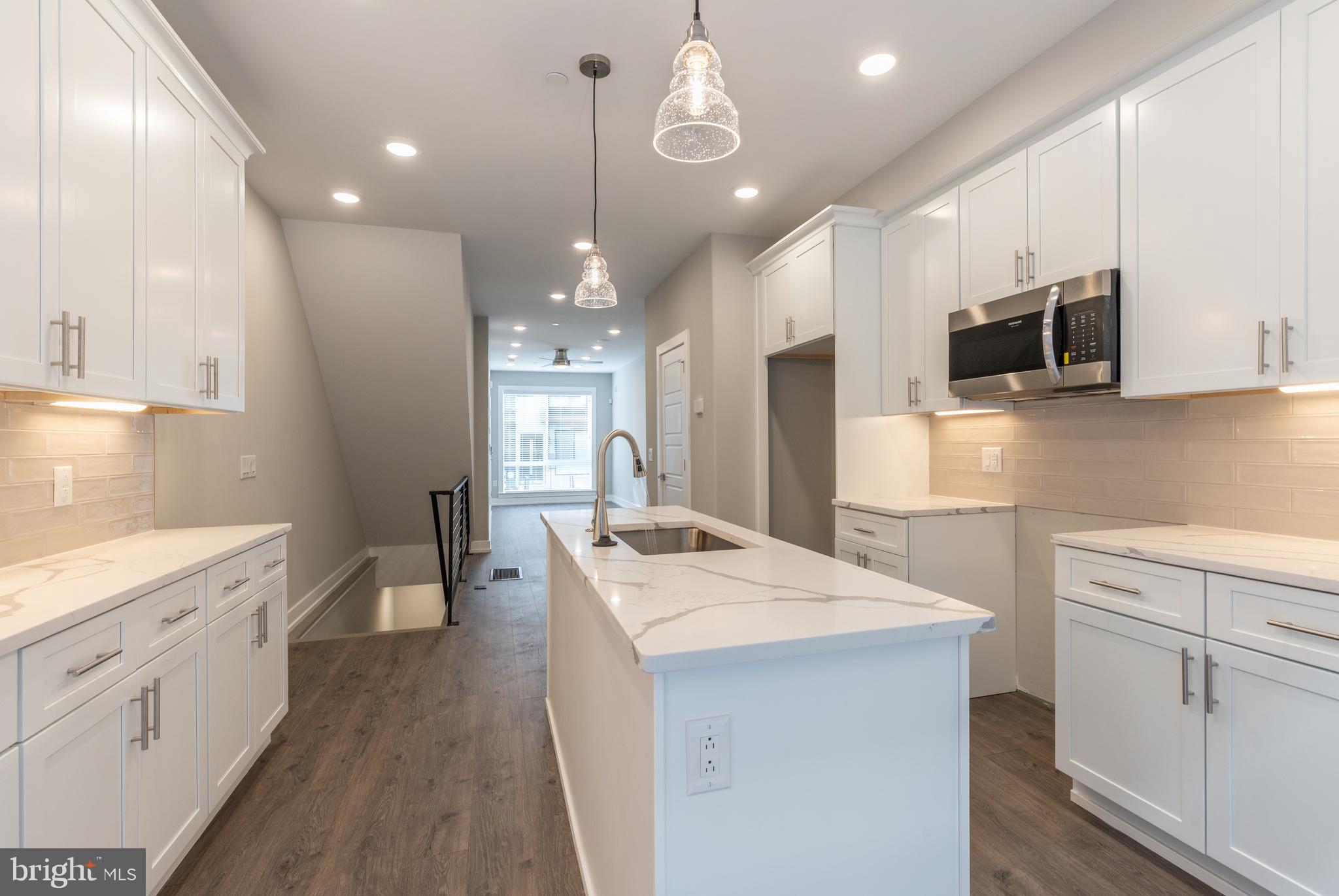 135 West Huntingdon Street, Unit 1 Philadelphia, PA 19133 - Photo 6 of 29 a kitchen with a sink a counter top space stainless steel appliances and cabinets
