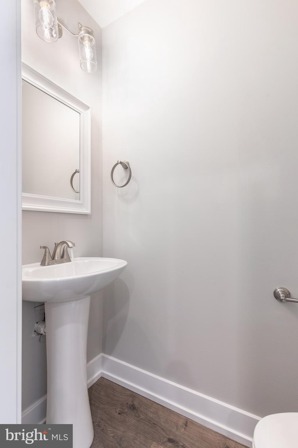 135 West Huntingdon Street, Unit 1 Philadelphia, PA 19133 - Photo 7 of 29 a bathroom with a sink a toilet and mirror