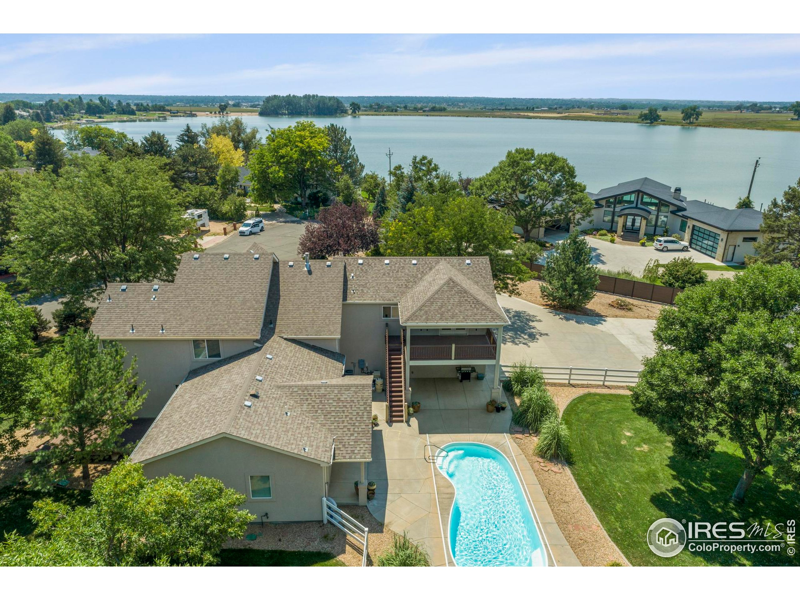 an aerial view of a house with a lake view
