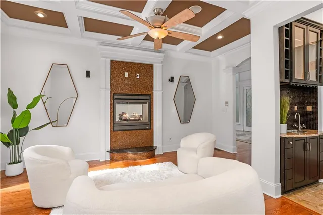 a bedroom with a bed a clock on the wall and dresser