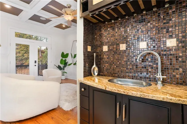 a kitchen with a sink and a mirror