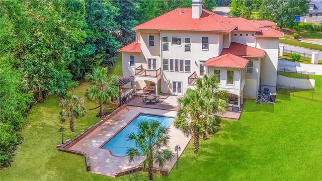 an aerial view of a house with yard swimming pool and outdoor seating