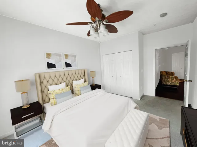 a bedroom with a bed and a lamp