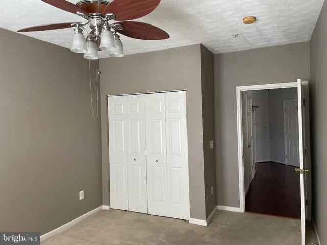 a view of a livingroom with a chandelier fan
