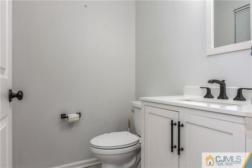 31 Hancock Road Piscataway, NJ 08854 - Photo 14 of 29 a bathroom with a granite countertop toilet sink and mirror