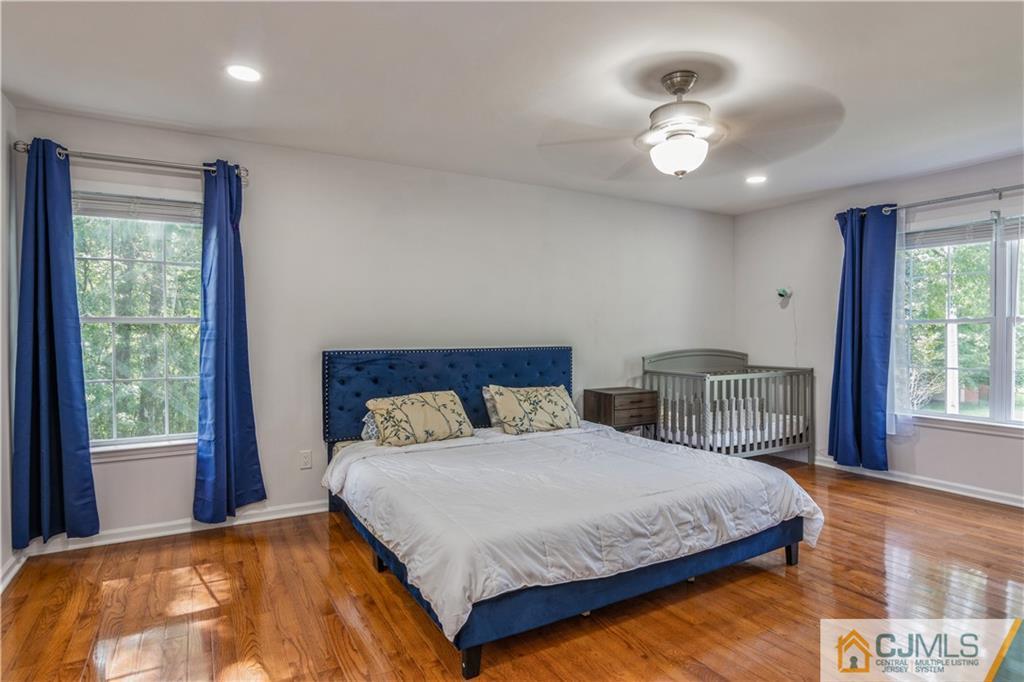 31 Hancock Road Piscataway, NJ 08854 - Photo 15 of 29 a bedroom with a large bed and a chandelier