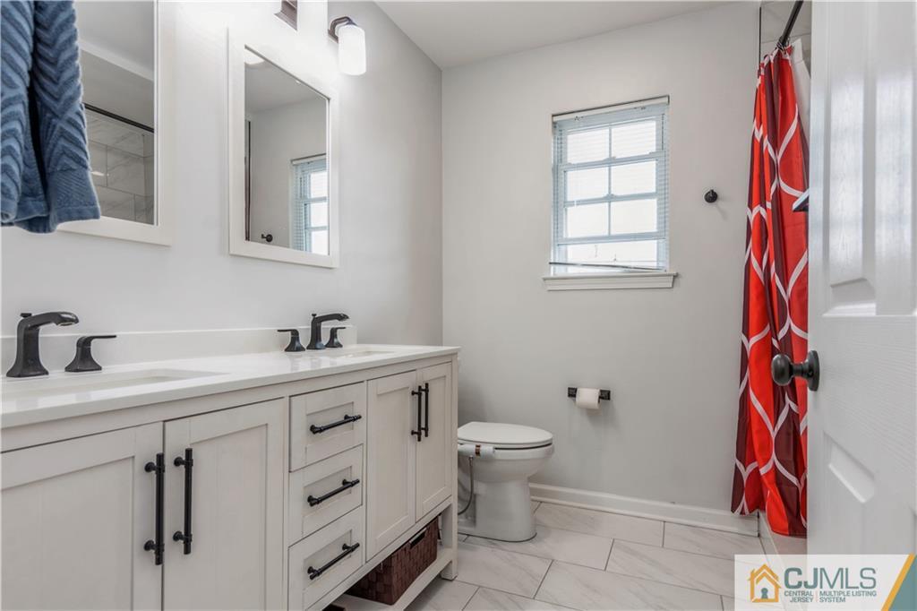 31 Hancock Road Piscataway, NJ 08854 - Photo 18 of 29 a bathroom with a sink toilet and a mirror