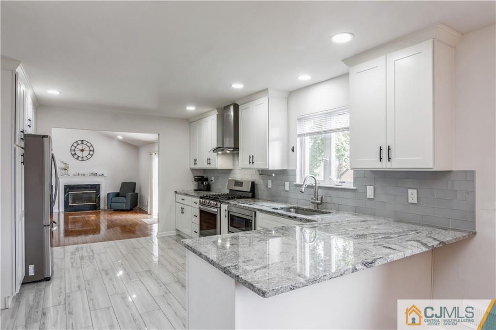 31 Hancock Road Piscataway, NJ 08854 - Photo 6 of 29 a kitchen with stainless steel appliances granite countertop a sink stove and refrigerator