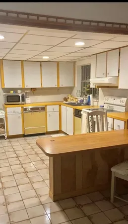 a kitchen with a stove a sink and cabinets