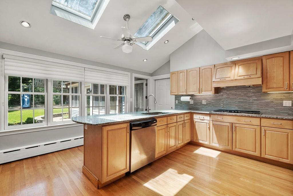 224 Rutledge Road Belmont, MA 02478 - Photo 10 of 30 a kitchen with stainless steel appliances granite countertop a sink cabinets and wooden floor