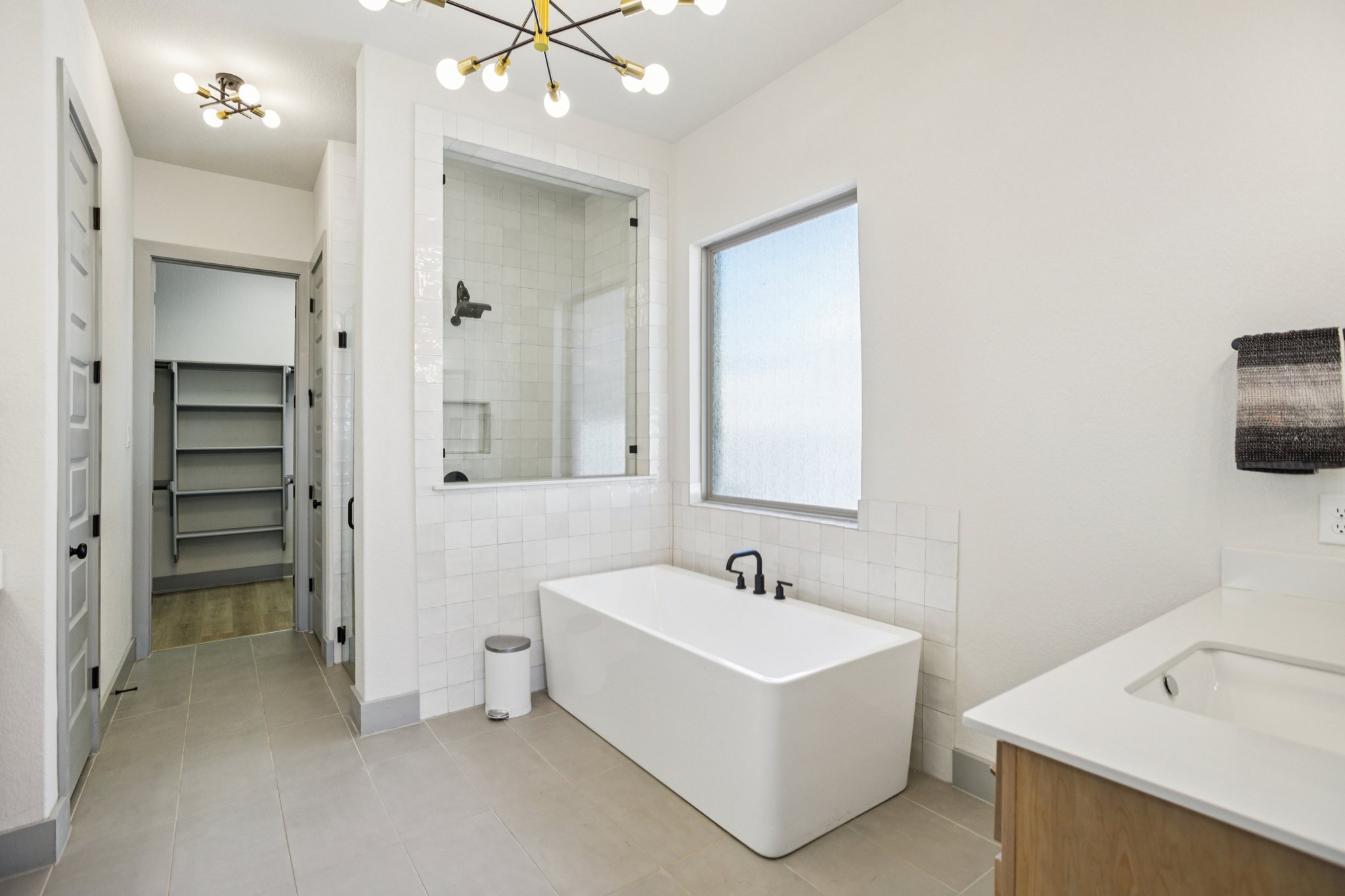 133 Lake Spring Circle Georgetown, TX 78633 - Photo 14 of 31 a white bath tub sitting next to a bathroom sink