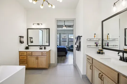 a en suite bathroom with a double vanity sink and mirror
