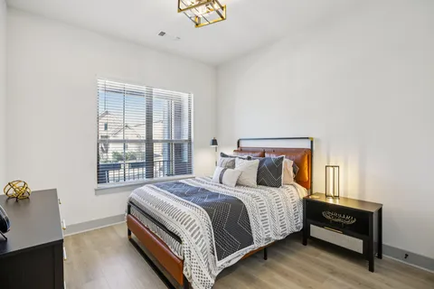 a bed sitting in a bedroom next to a window
