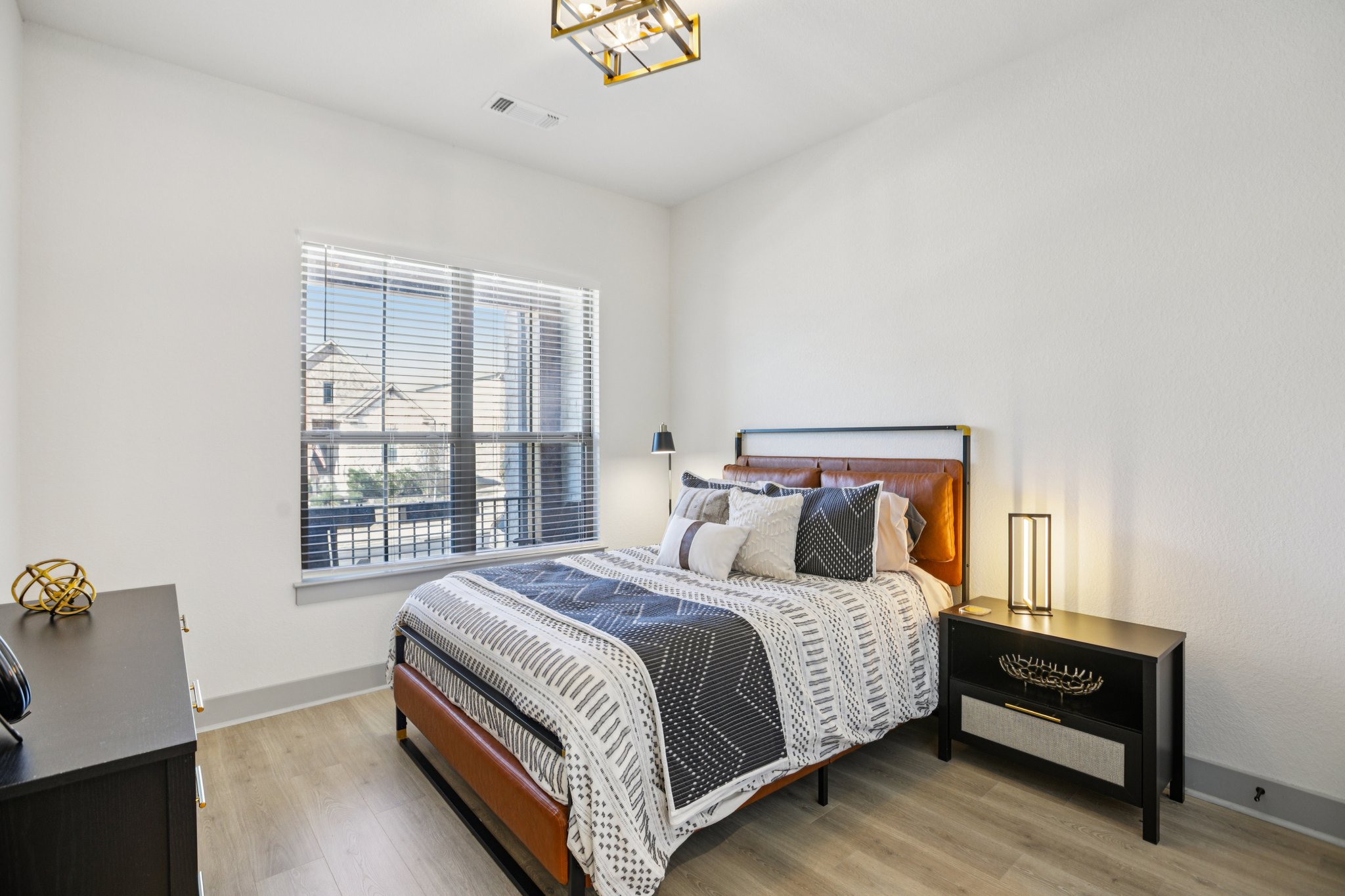 133 Lake Spring Circle Georgetown, TX 78633 - Photo 18 of 31 a bed sitting in a bedroom next to a window