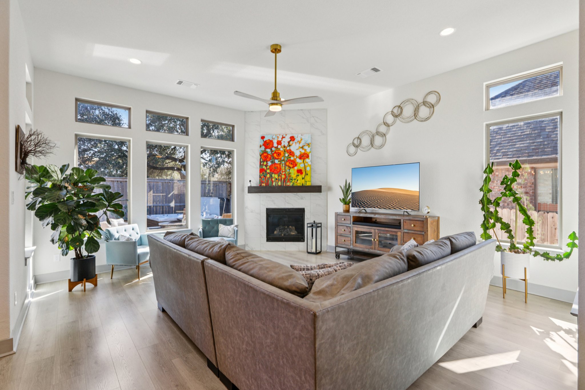133 Lake Spring Circle Georgetown, TX 78633 - Photo 2 of 31 a living room with furniture a fireplace and a potted plant