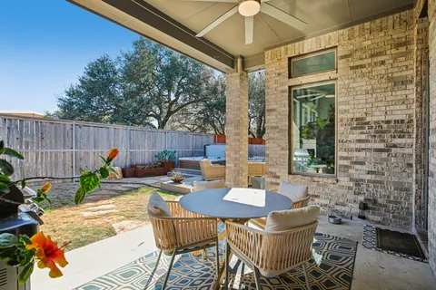 a view of a patio with a dining table and chairs