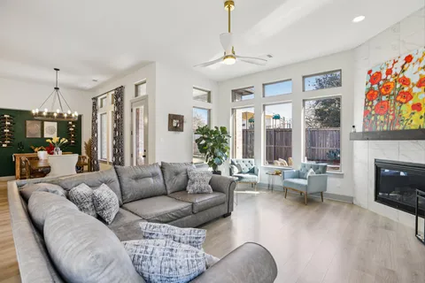 a living room with furniture fireplace and a large window