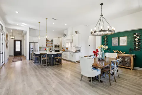 a dining room with furniture and wooden floor