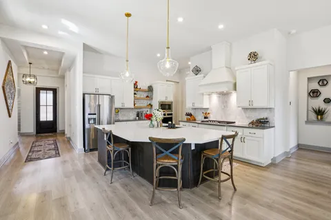 a large kitchen with a table and chairs