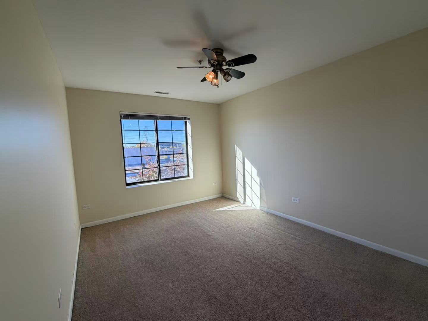 8255 Skokie Boulevard, Unit 406 Skokie, IL 60077 - Photo 12 of 16 an empty room with windows and fan