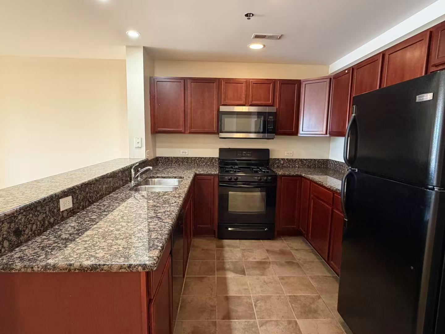 8255 Skokie Boulevard, Unit 406 Skokie, IL 60077 - Photo 2 of 16 a kitchen with stainless steel appliances granite countertop a refrigerator stove and microwave