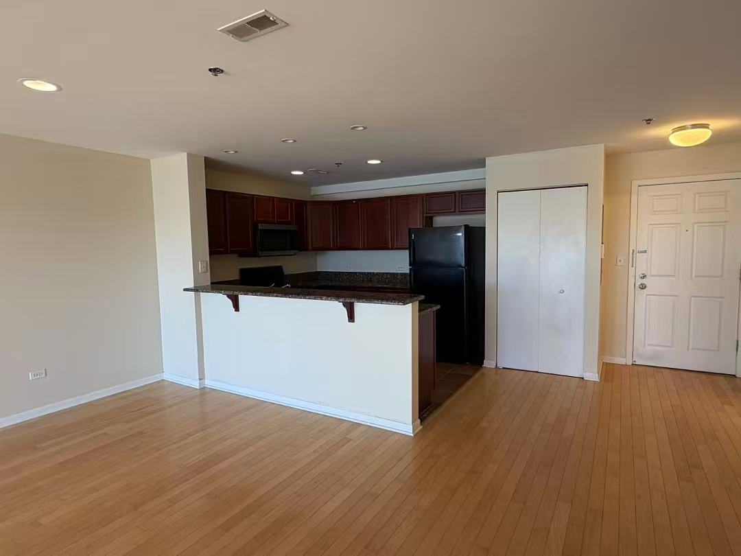 8255 Skokie Boulevard, Unit 406 Skokie, IL 60077 - Photo 4 of 16 a kitchen with stainless steel appliances granite countertop a refrigerator and a microwave