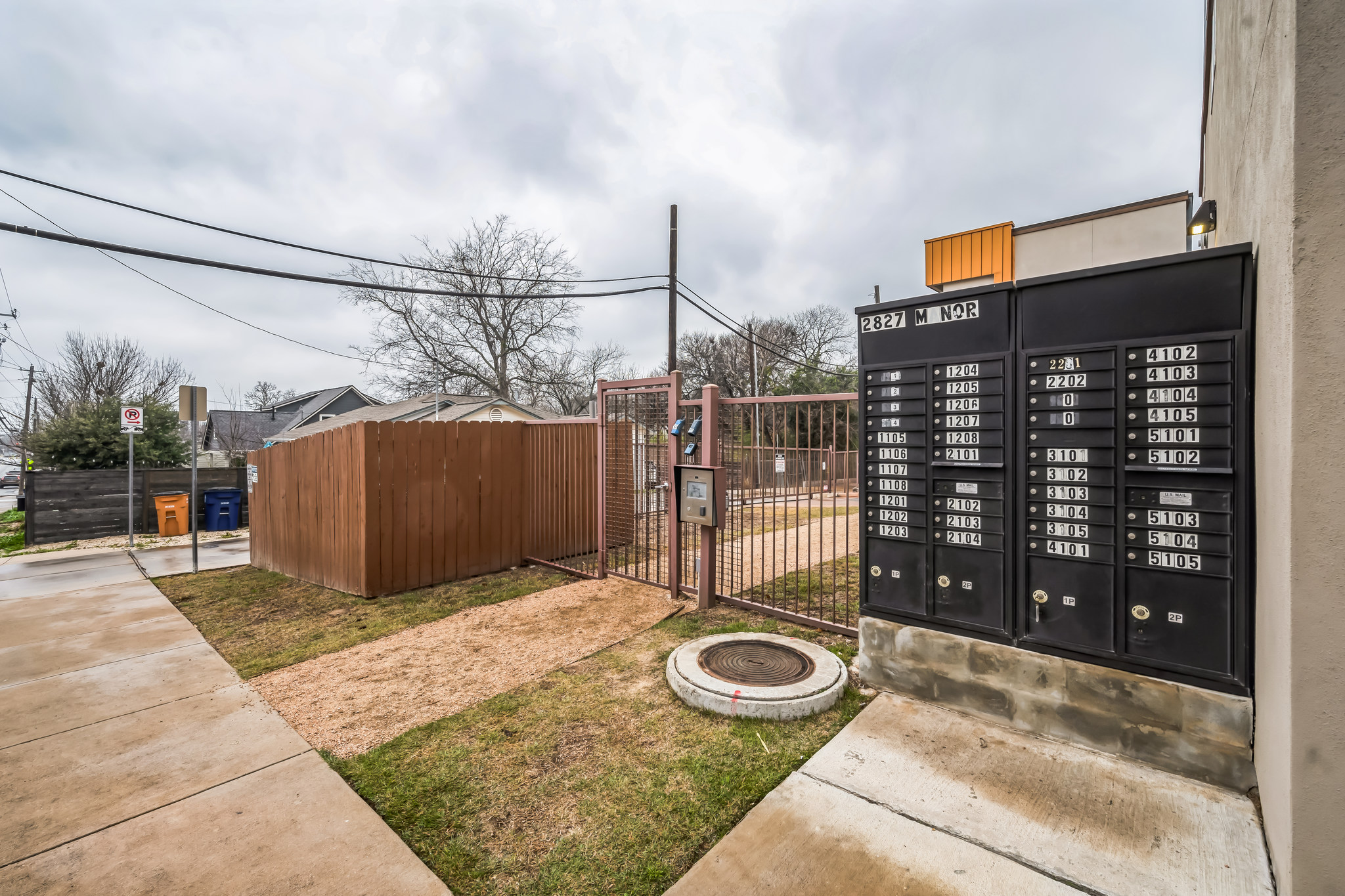 2827 Manor Road, Unit 3104 Austin, TX 78722 - Photo 20 of 30 Secure community entrance with well-maintained fencing and convenient mailboxes for residents.