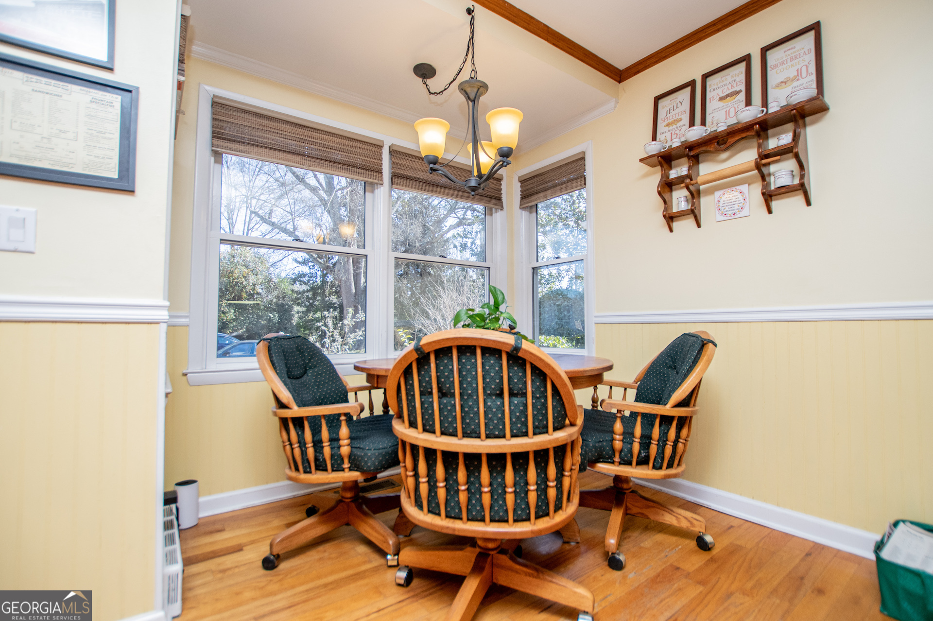 310 Kramer Street Carrollton, GA 30117 - Photo 18 of 99 a dining room with furniture a chandelier and wooden floor