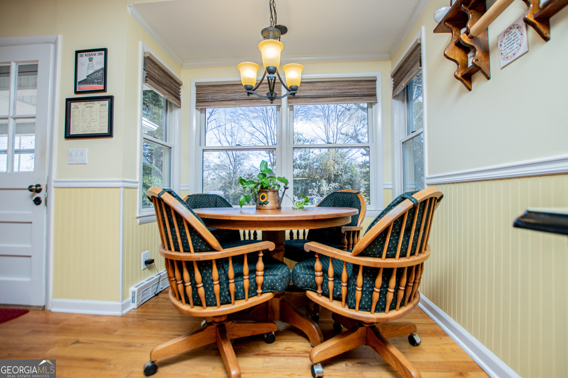 310 Kramer Street Carrollton, GA 30117 - Photo 19 of 99 a view of a dining room with furniture a chandelier and wooden floor