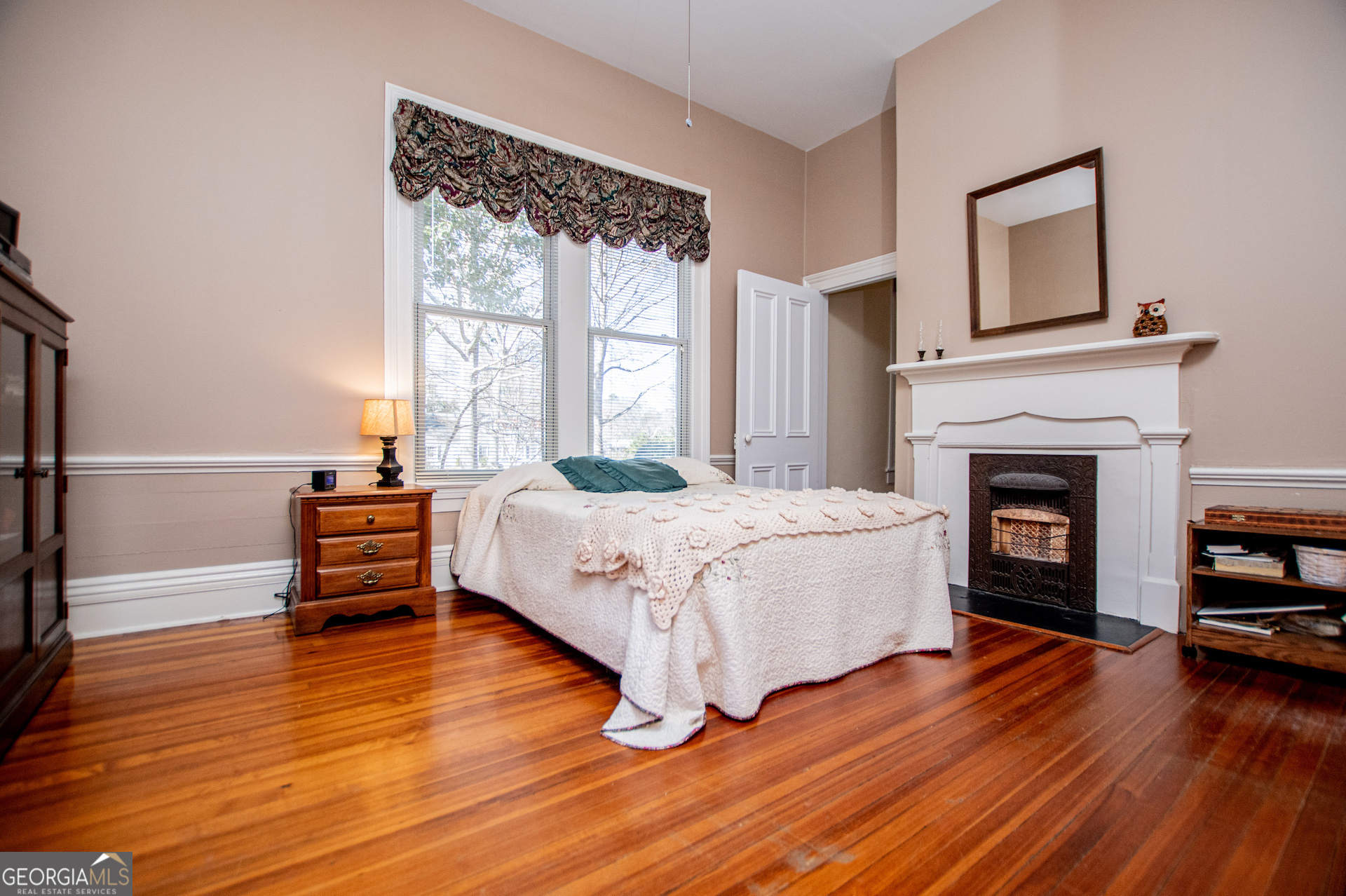 310 Kramer Street Carrollton, GA 30117 - Photo 39 of 99 a spacious bedroom with a bed and a fireplace
