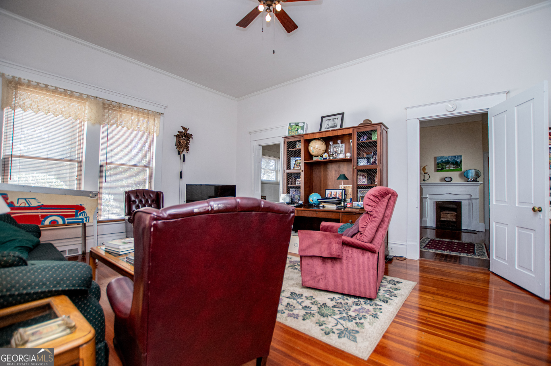 310 Kramer Street Carrollton, GA 30117 - Photo 43 of 99 a work room with furniture wooden floor and a rug