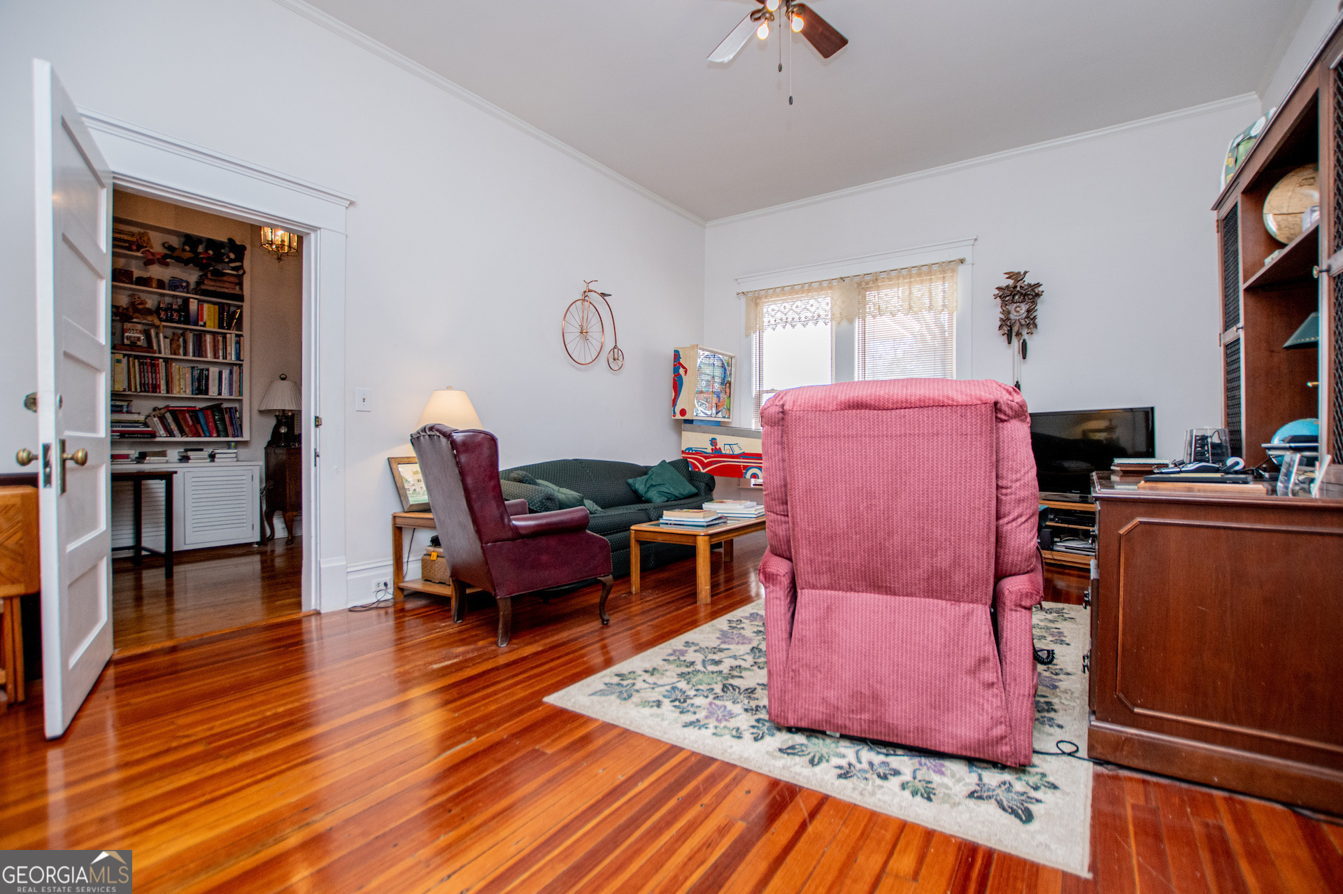 310 Kramer Street Carrollton, GA 30117 - Photo 44 of 99 a living room with furniture a flat screen tv and wooden floor