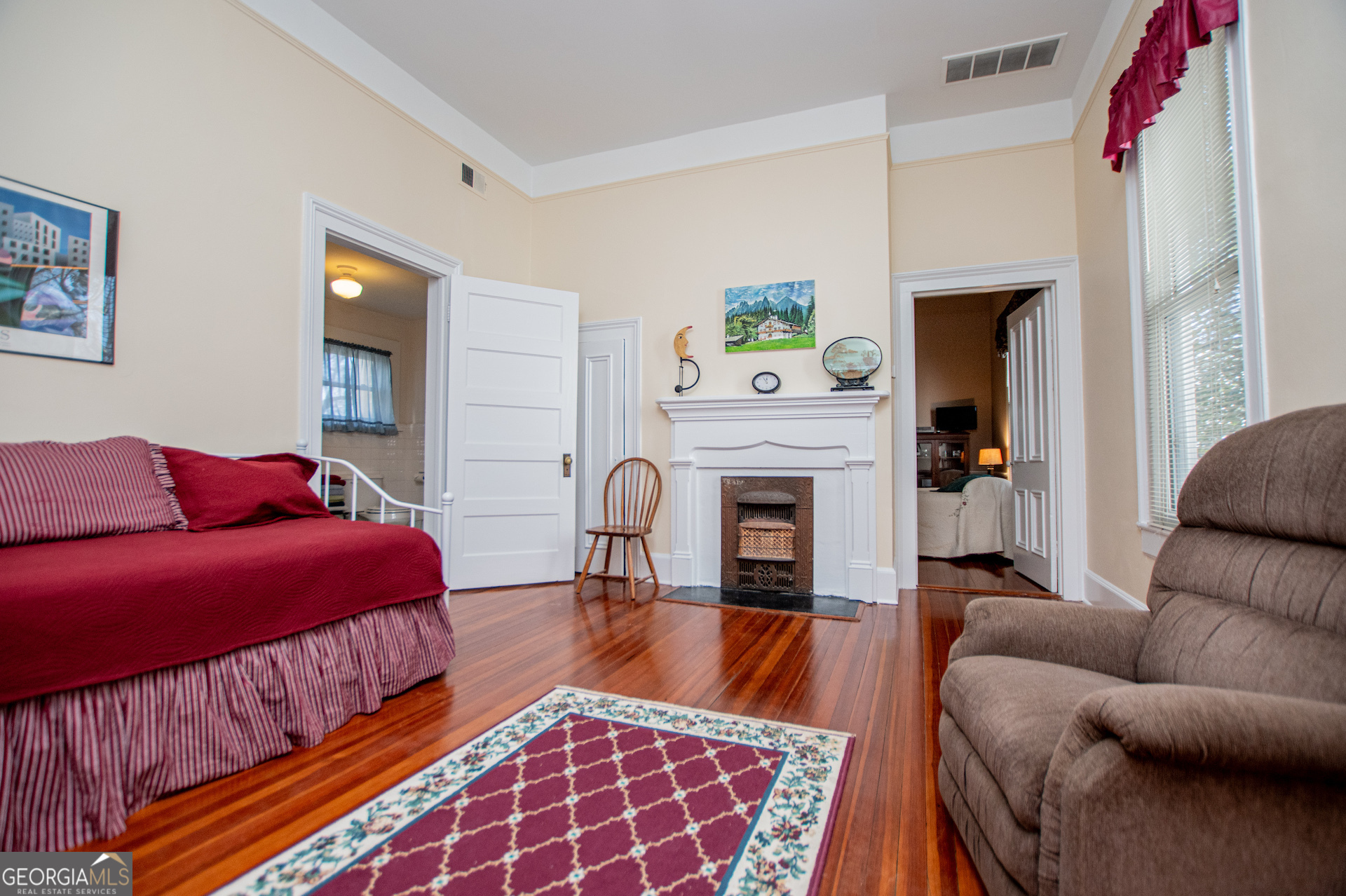 310 Kramer Street Carrollton, GA 30117 - Photo 49 of 99 a living room with furniture a fireplace and a window