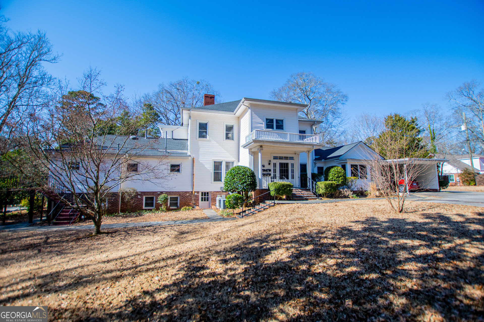 310 Kramer Street Carrollton, GA 30117 - Photo 71 of 99 a front view of a house with a yard covered with trees