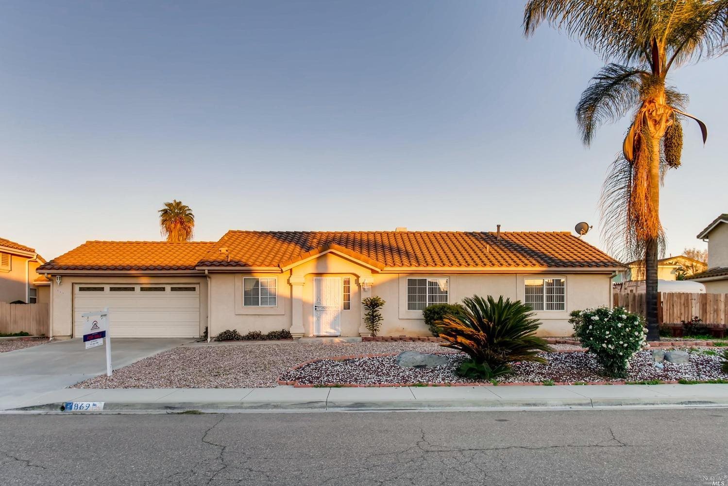 869 St George Place Spring Valley, CA 91977 - Photo 1 of 1 a front view of a house with a yard and garage